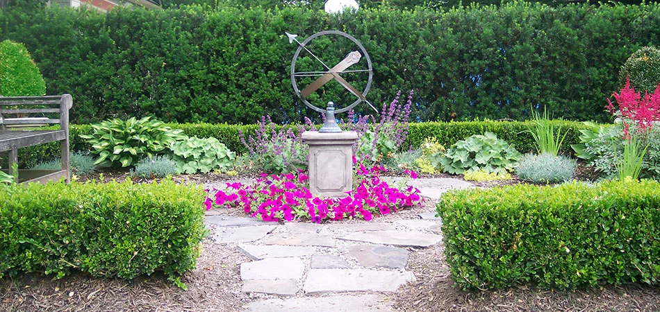 Landscaped garden with flags, plants, and flowers in Plainfield, NJ.