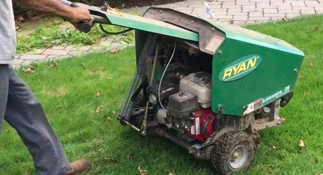 Aerating the front lawn in preparation for overseeding.